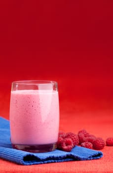 A raspberry smoothie on a red and blue background