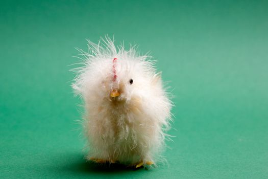 A little yellow chick easter decoration isolated on green