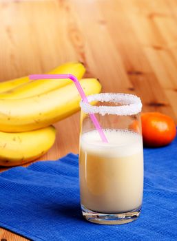 A smoothie made from oranges and bananas in an elegant glass