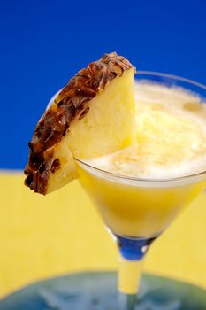 A pineapple smothie isolated over blue