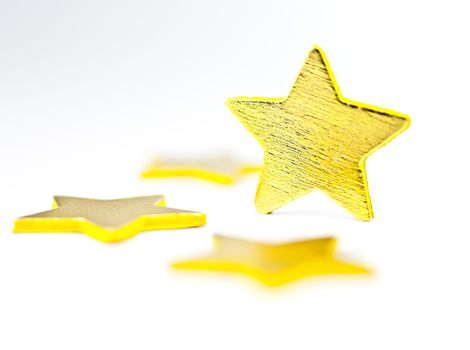 On a white background golden stars, one star in a vertical position.