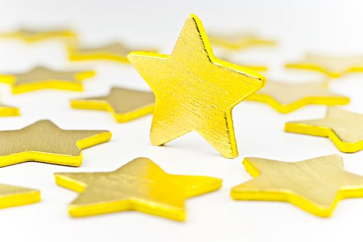 On a white background golden stars, one star in a vertical position.
