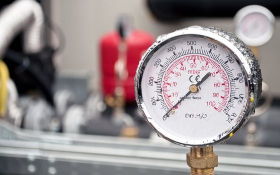 Industrial hydraulic round barometer with rain over it