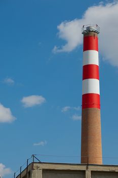 Industrial chimney against blue sky