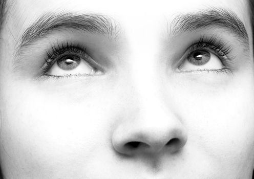 Part of a female face looking upwards