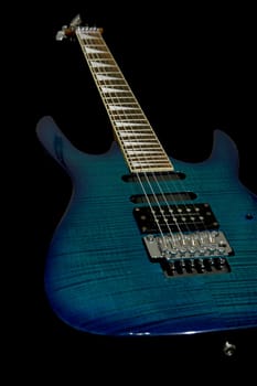 Blue electric guitar with superstrat shape isolated on black