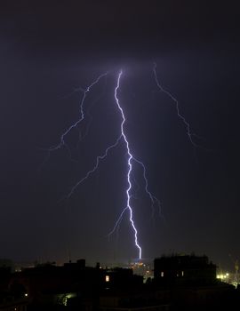 Lightning into the sea during a storm near the port of Genoa, Italy