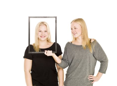 Girl holding a frame in front of her friends face