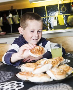 Young Boy reaching for sweets in the kitchen