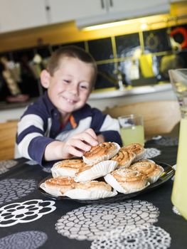 Young Boy reaching for sweets in the kitchen