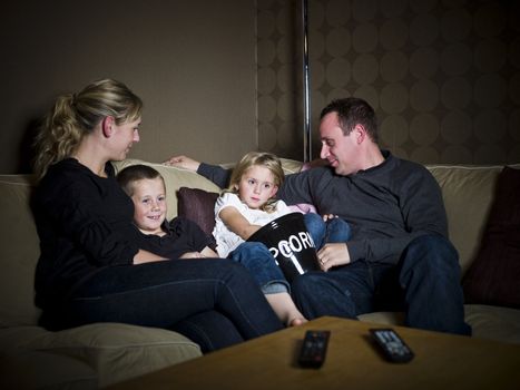 Family in front of Television in a sofa