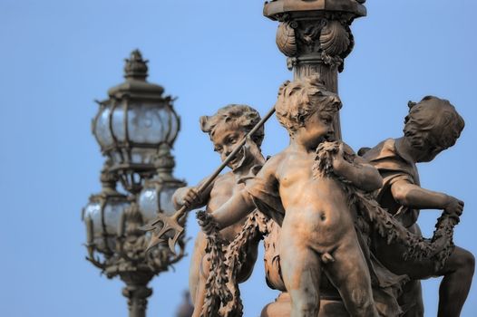 Bridge Alexandre III. Sculpture and lamppost. Photo with tilt-shift effect