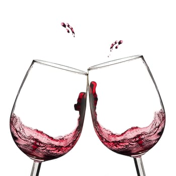 Two wine glasses in toasting  with splash. 