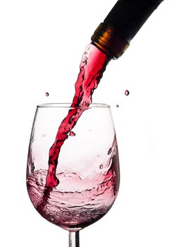 Wine splash on a glass, white background.