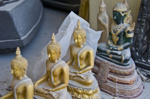 little dusty buddha statues in a thai temple