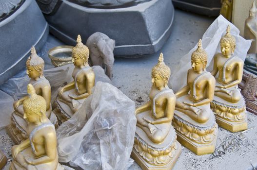 little dusty buddha statues in a thai temple