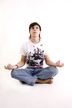Young man meditating in the lotus pose