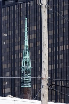 Ornate steeple against the background of an office building