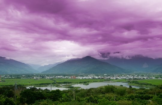 It is a beautiful mountain and clouds with tree.