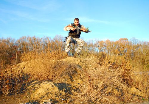 Military physical training, making jump�s with weapon in his hands