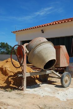 orange cement mixer at a construction site