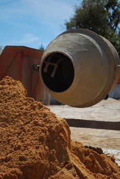 orange cement mixer at a construction site
