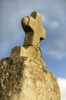 Rustic concrete cross on a cemetary marker
