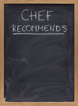 chef recommends title handwritten with white chalk on blackboard with eraser smudges, copy space below