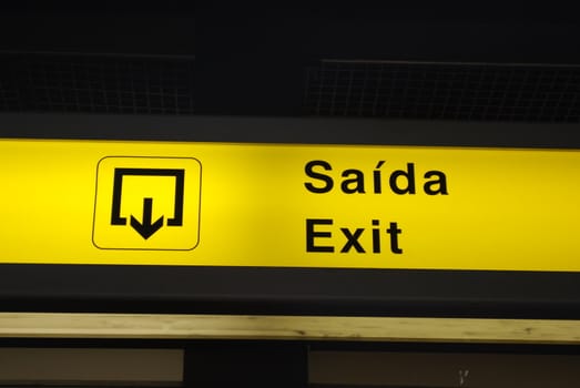 yellow exit sign at a international airport