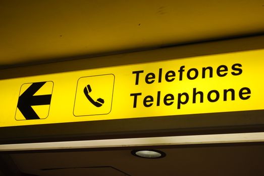 yellow and black telephone sign on international airport
