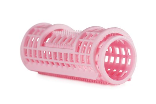 One pink hair roller isolated over white