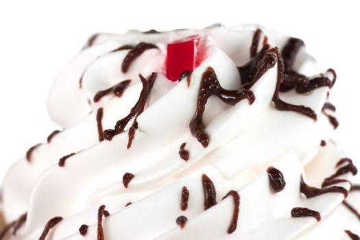 Macro view of whipped cream with chocolate icing isolated over white