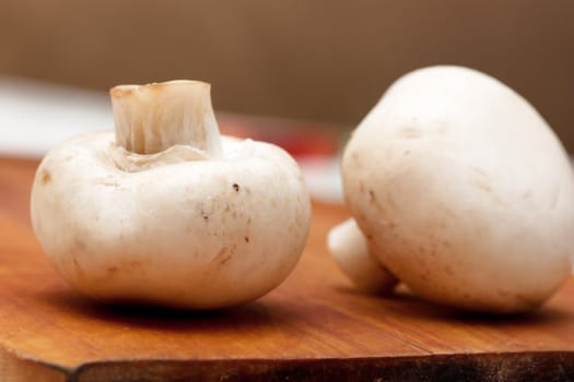 Two mushrooms on a cutting board