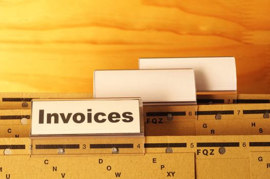 invoice or invoices concept with business folder in office showing paperwork