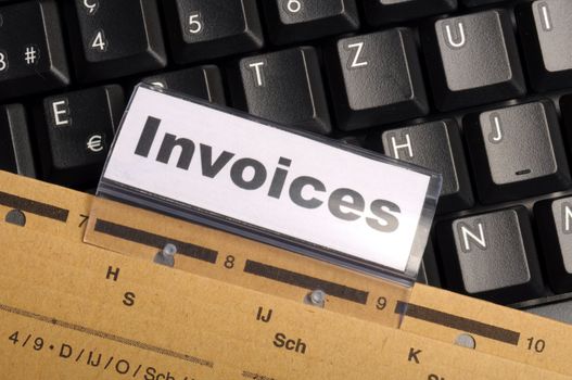 invoice or invoices concept with business folder in office showing paperwork