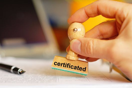 certificated on stamp in office showing bureaucracy concept