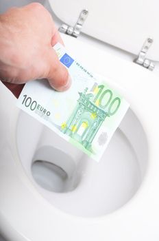 money and toilet showing financial crisis concept