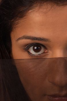 Middle eastern woman with intense look from behind a veil