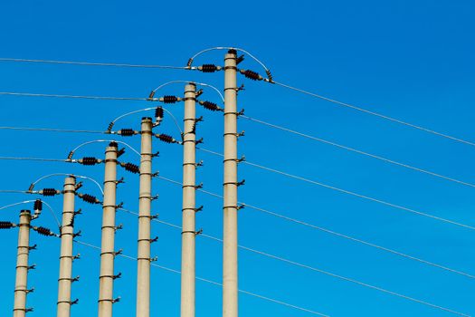 High-voltage pole against a blue sky 