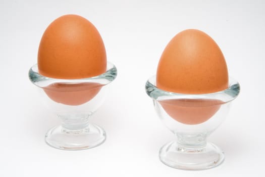 Two eggs in a glass cup