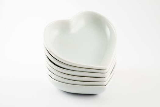 Stack of pottery hearts isolated on a white background