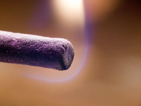 Macroshot of an incense stick just being lit