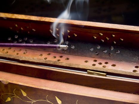 Closeup of an incense stick smoking