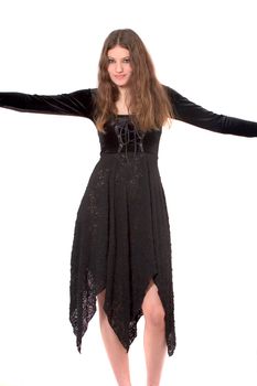 Beautiful teenager in gothic dress stretching her arms out to the side