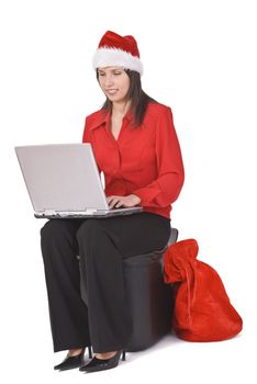 Young woman in red clothes and hat working on a laptop. Shot with Canon 70-200mm f/2.8L IS USM