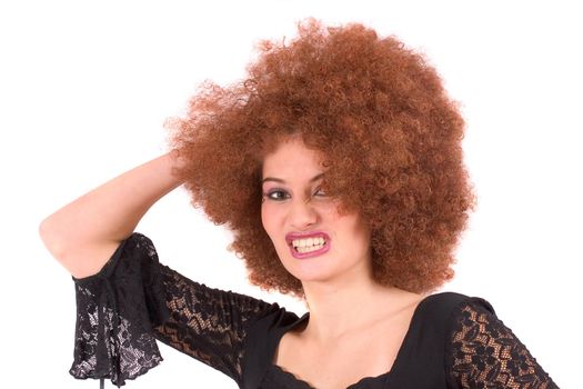 Beautiful young teenager with red afro wig pulling a face