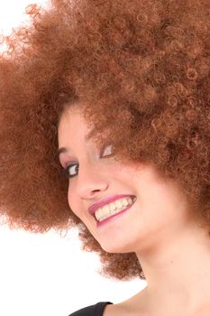 Lovely young teenager with red afro wig pulling faces
