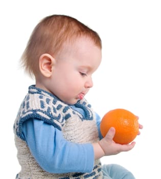 Study of the orange by small boy, useful and tasty fruit