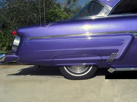 This is a pinstriped rear fender of a purple pearl 1954 Ford streetrod.