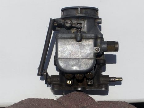 A two barrel carburettor belongs to a 1955 Ford Victoria.